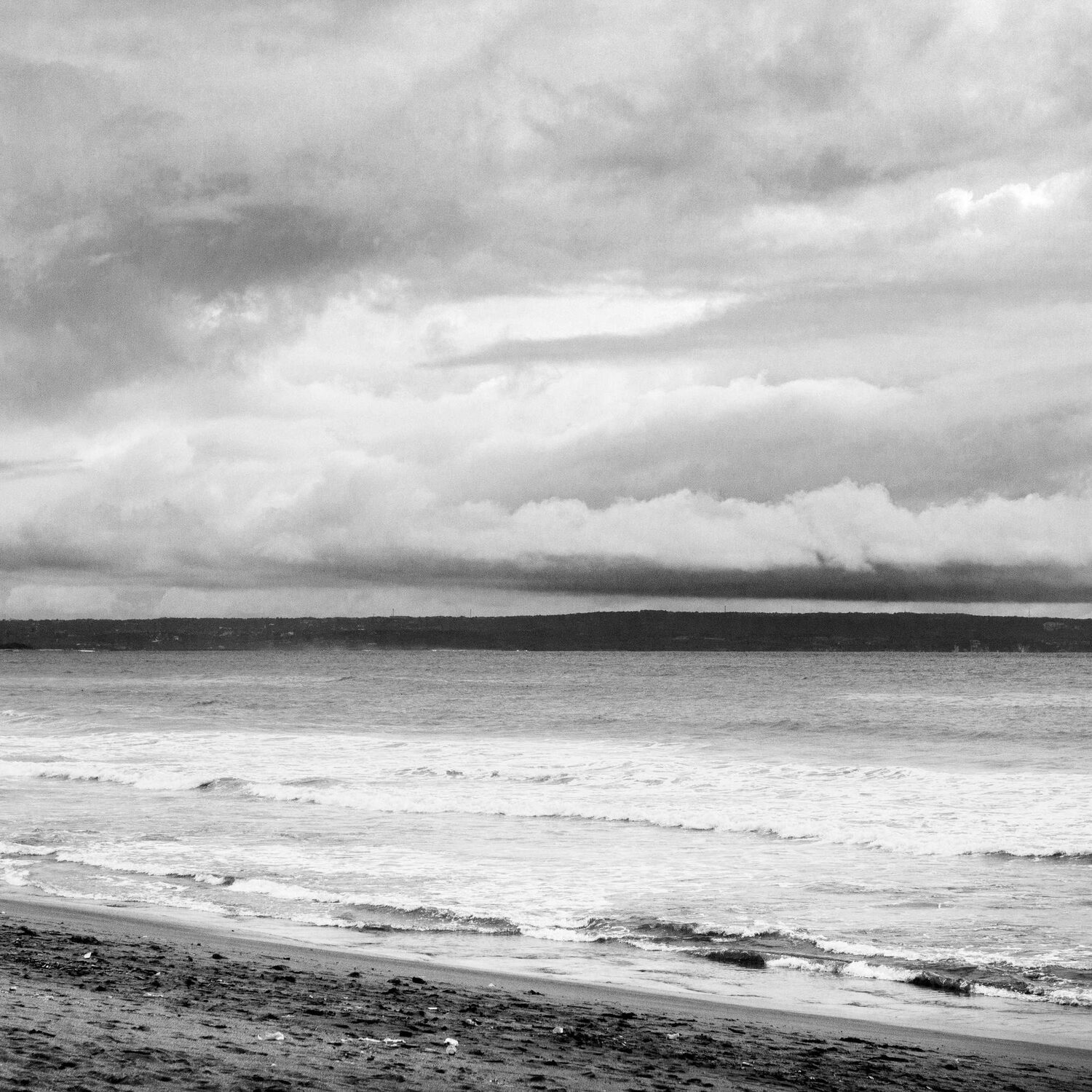 Black and white beach with breaking waves